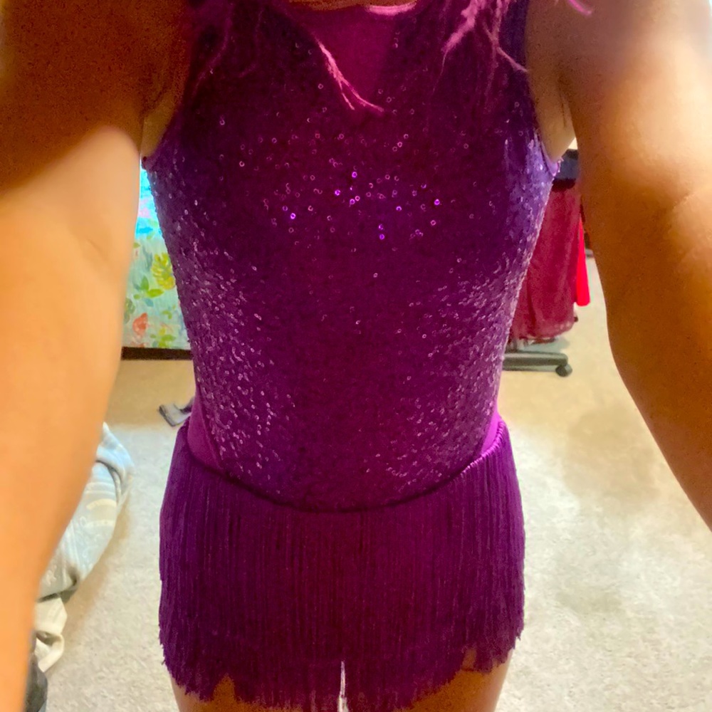 A purple feather/sequent dress with open back Frills on the bottom so cute kids